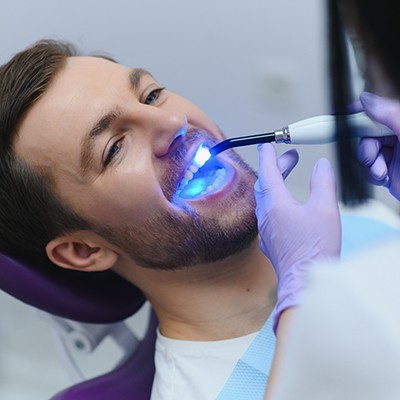 A man undergoing a tooth-colored fillings treatment