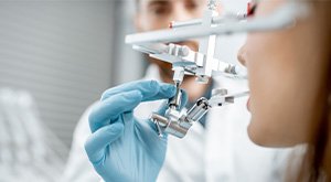 Patient getting jaw measured for occlusal adjustment for TMJ