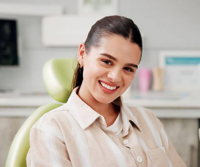 Portrait of smiling, happy patient in dental treatment chair