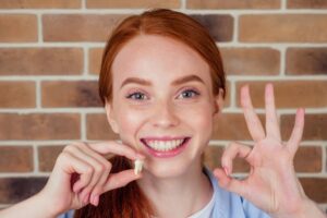 Woman smiling after her wisdom teeth extraction