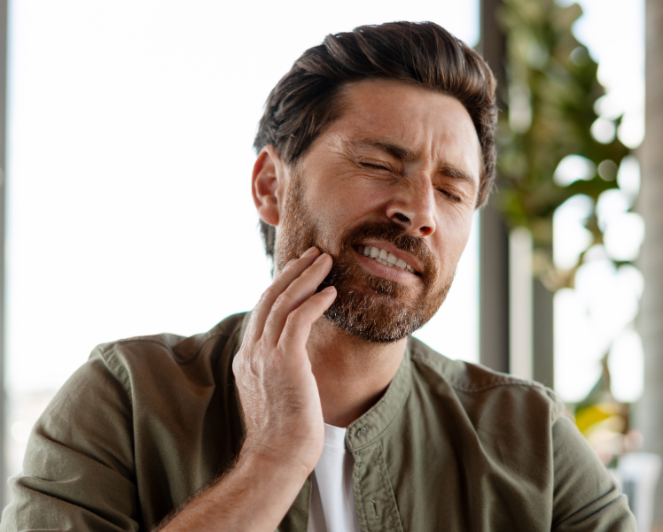 Man holding jaw in pain